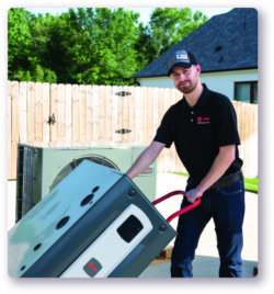 trane installer holding a furnace on a dolly